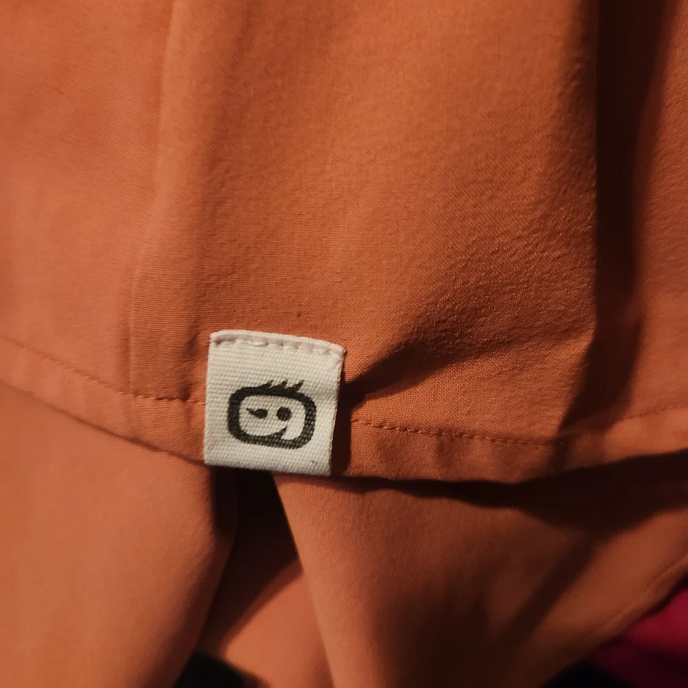 WonderWink V-Neck Scrub Top in Warm Orange. Matching Pants Available - Picture 2 of 2